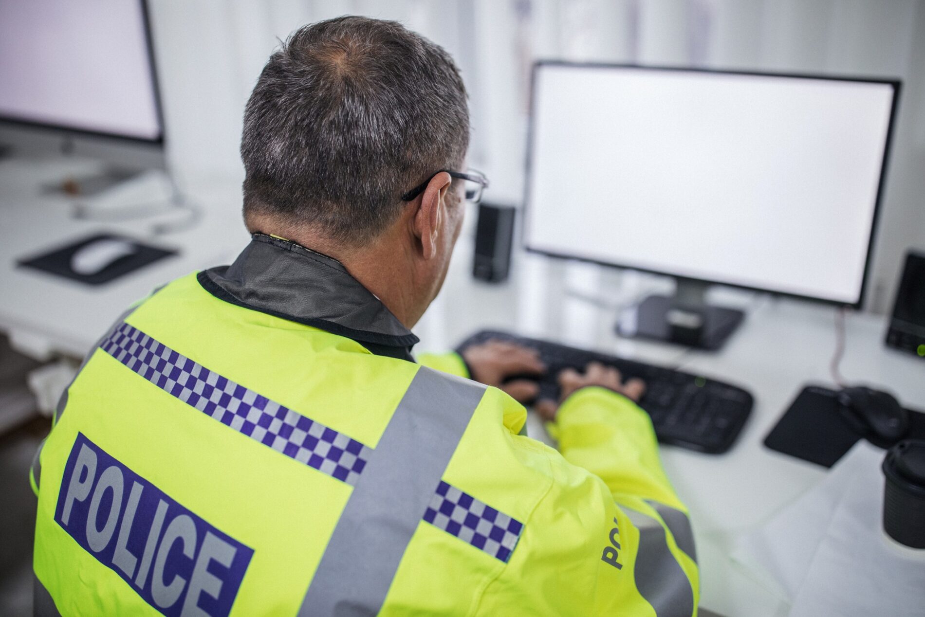 Policeman-working-at-desktop-computer-optimised