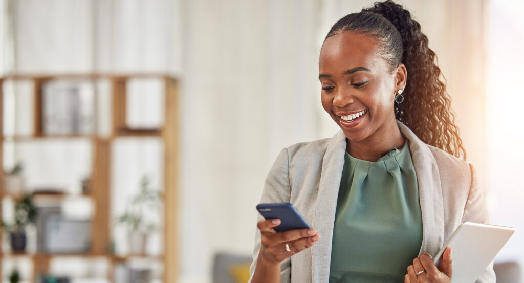 A businesswoman checks her mobile phone.